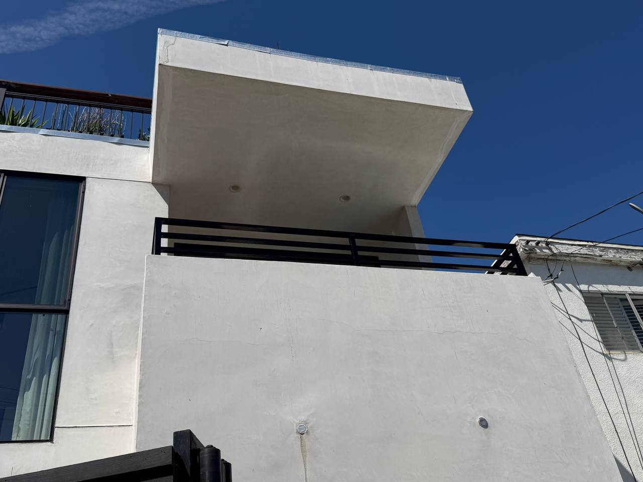 Exterior view of restored glossy black balcony railing in Venice Beach
