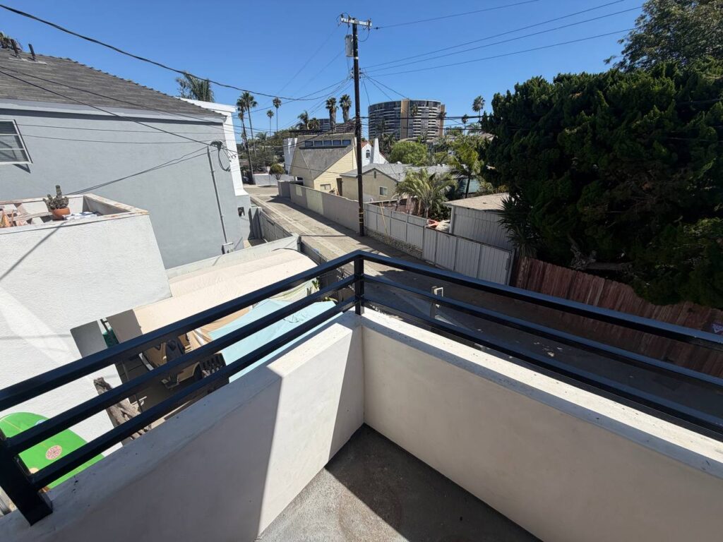 Finished glossy black balcony railing after restoration in Venice Beach